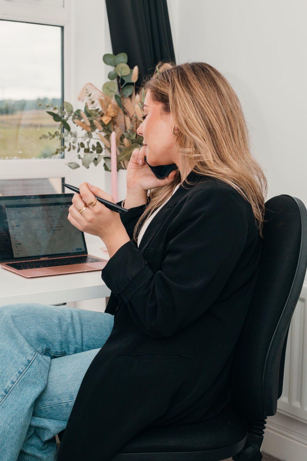 Phoebe Mayner on a call at her desk