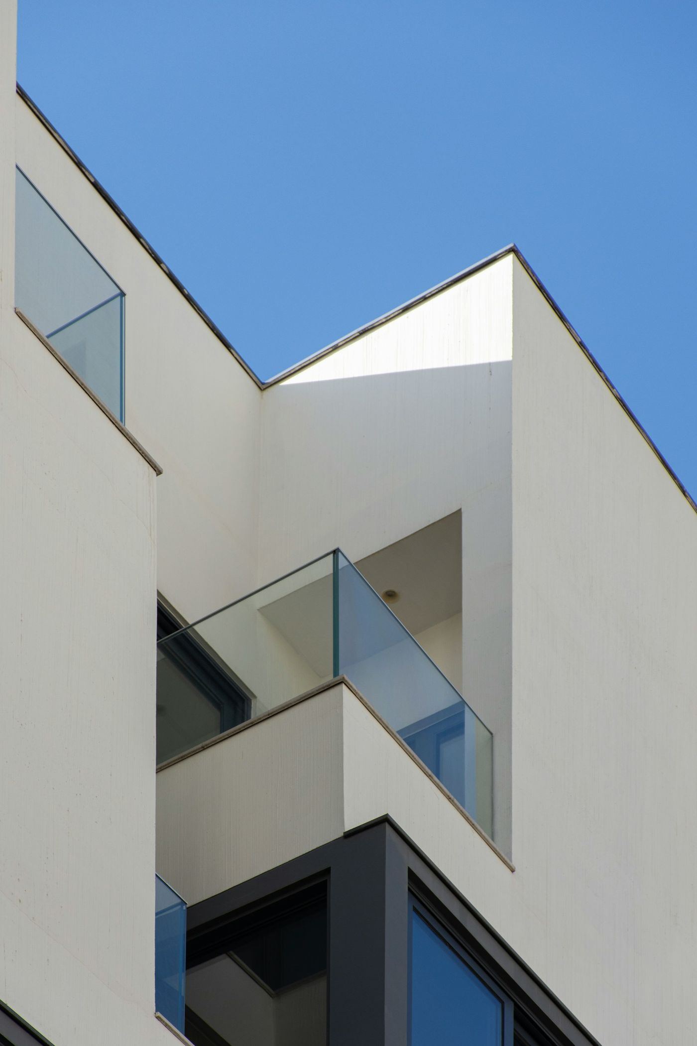 White modernist architecture against a clear blue sky