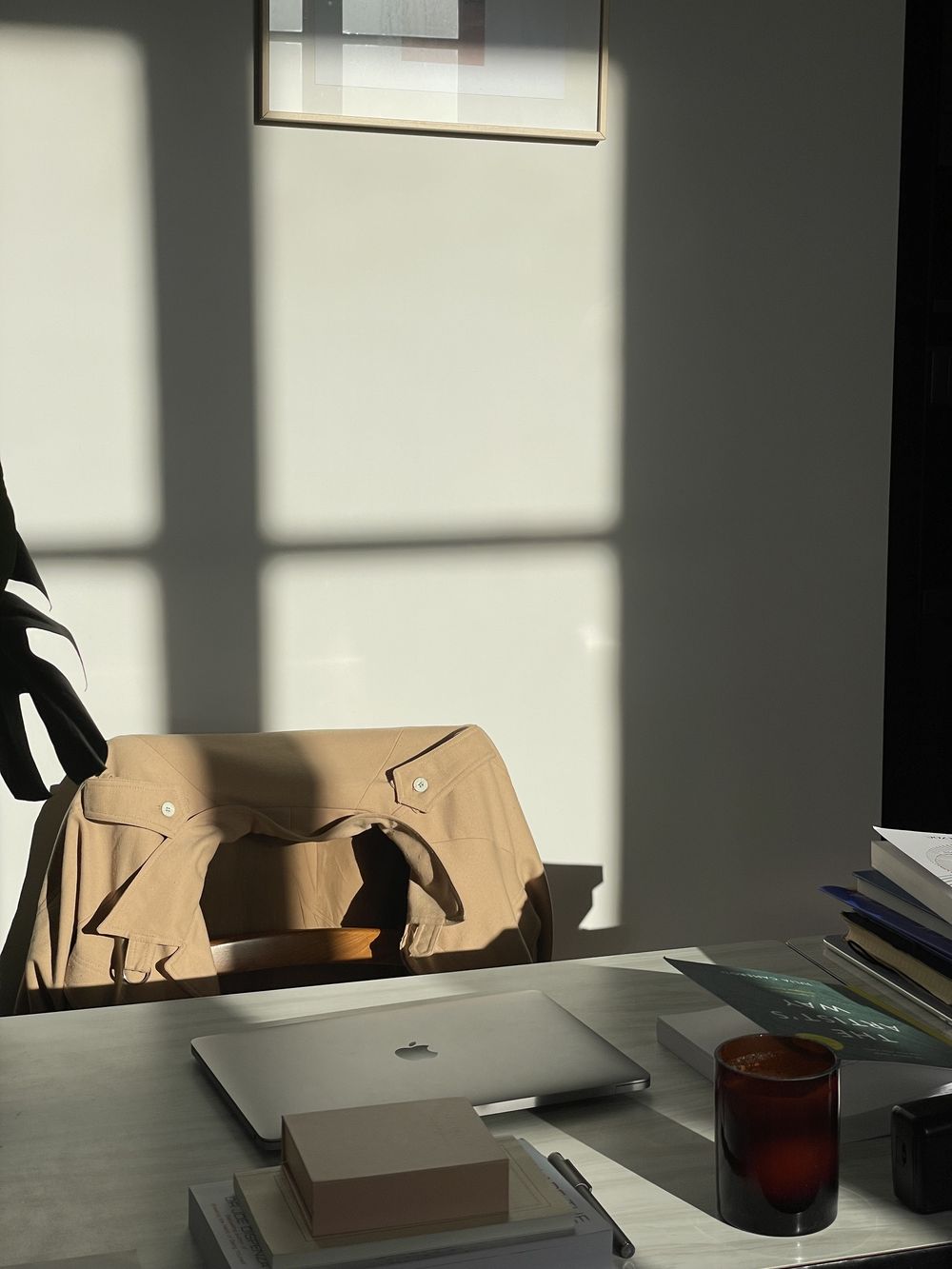 A desk in soft window light with long shadows